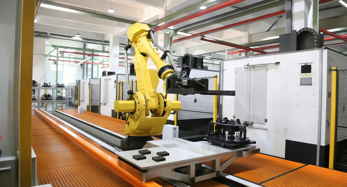 Robotic gantry loading a row of CNC machining centers on the production floor