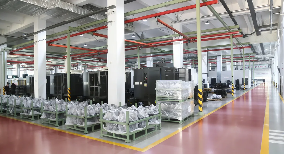 Wide view of the Baichang machining floor with CNC machines and staged drivetrain parts
