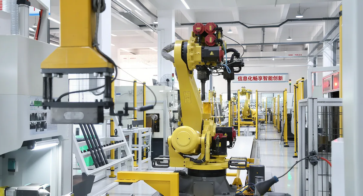 Industrial robot arm tending an automated axle production line at the Baichang plant